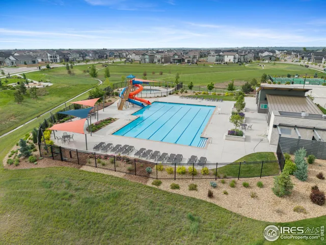 an aerial view of a house with a garden and lake view