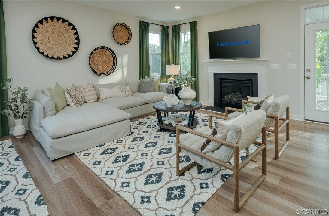 8931 Lewdown Place Chesterfield, VA 23832 - Photo 2 of 19 a living room with furniture a flat screen tv and a fireplace