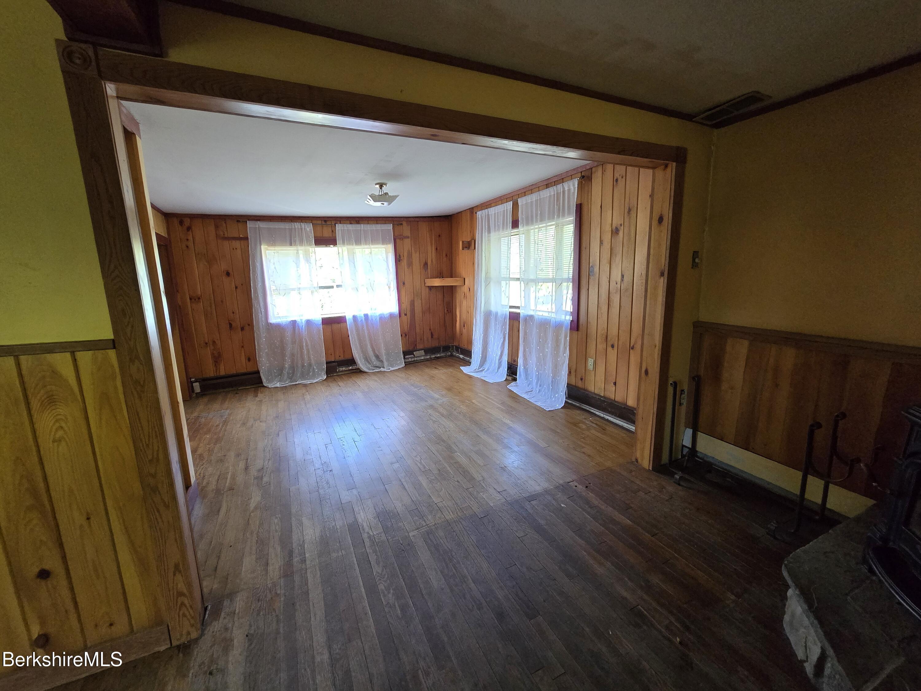 450 River Road Clarksburg, MA 01247 - Photo 17 of 45 a view of empty room with wooden floor and fan