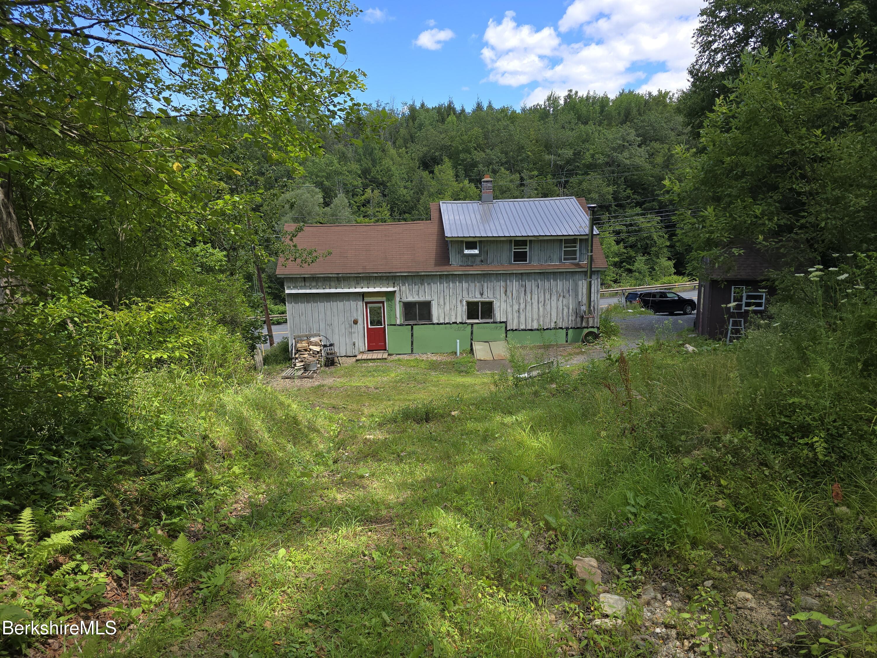 450 River Road Clarksburg, MA 01247 - Photo 3 of 45 a view of a house with a big yard potted plants and large tree