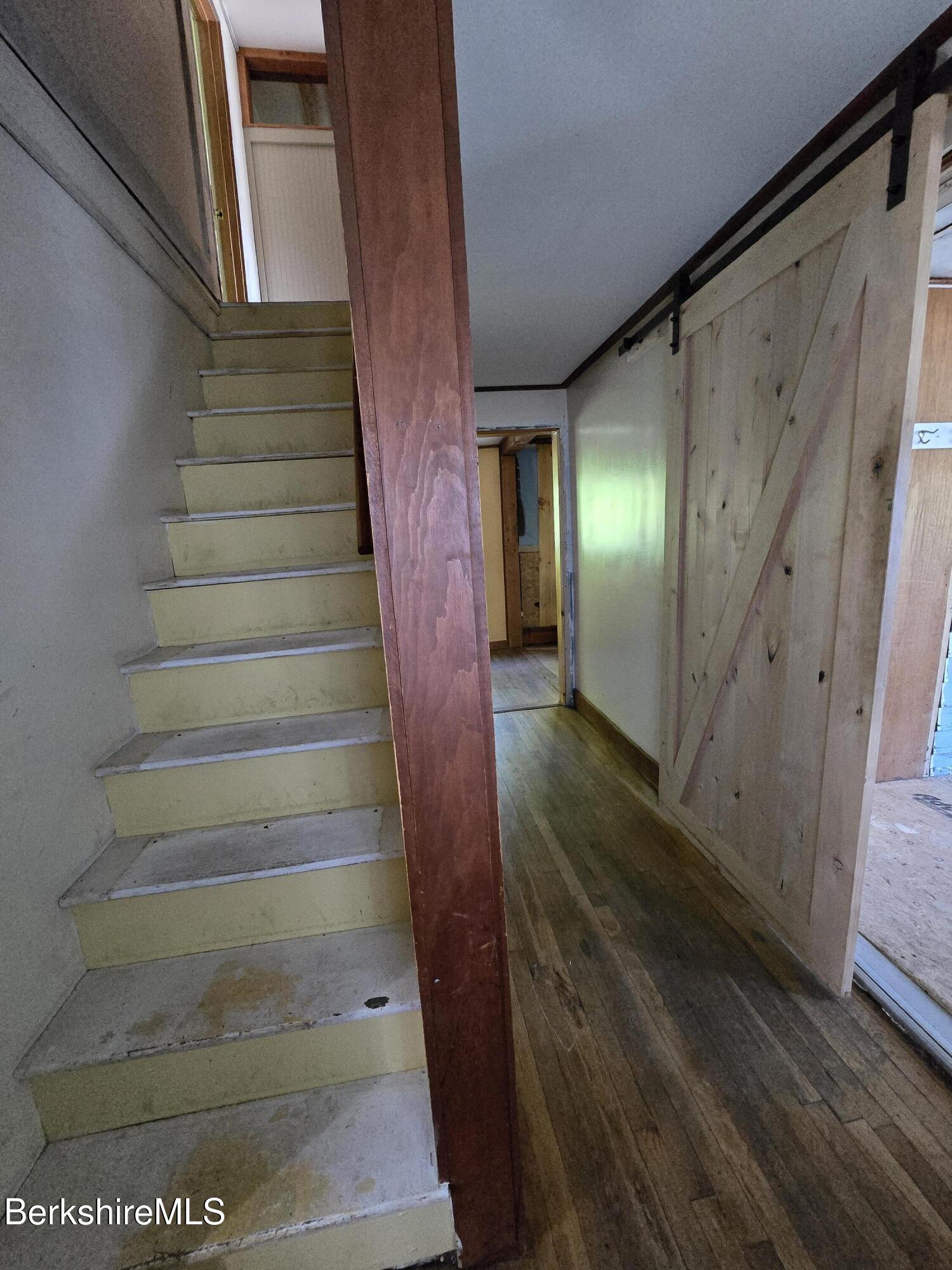 450 River Road Clarksburg, MA 01247 - Photo 33 of 45 a view of staircase with lots of frames on wall and wooden floor