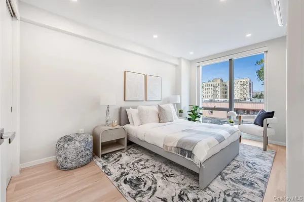 a bedroom with a large bed and a window