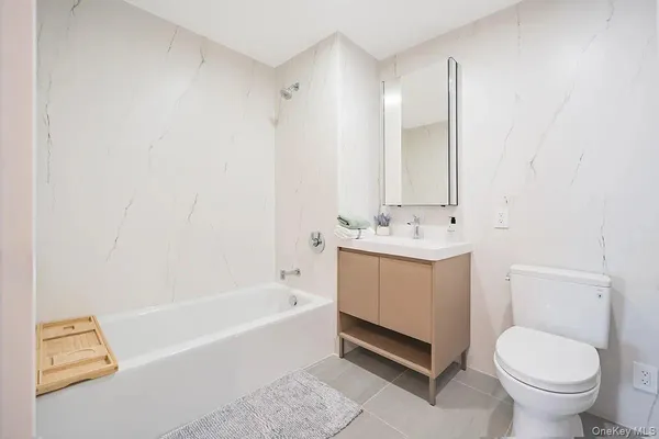 a bathroom with a sink a toilet and bathtub