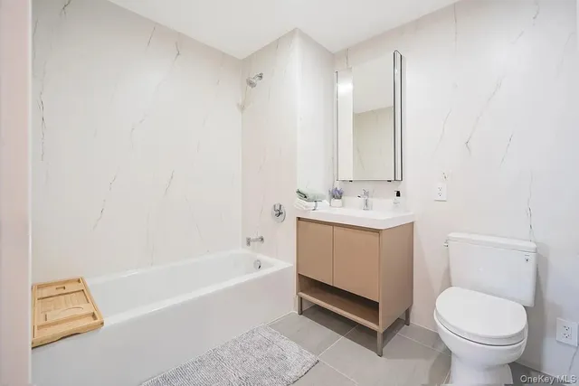 a bathroom with a sink a toilet and bathtub