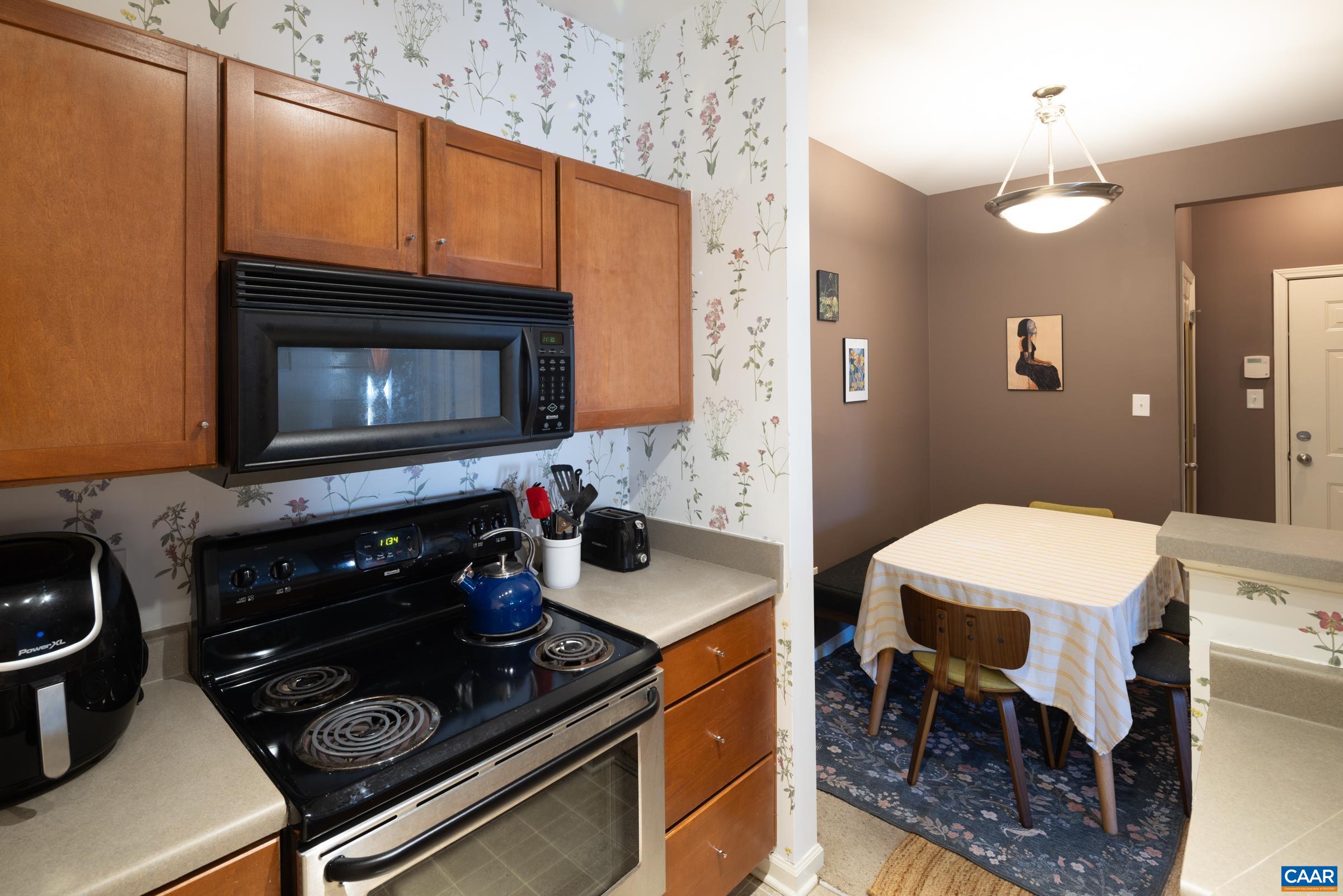 750 Walker Square, Unit 3D Charlottesville, VA 22903 - Photo 12 of 18 a kitchen with a stove a sink and a microwave