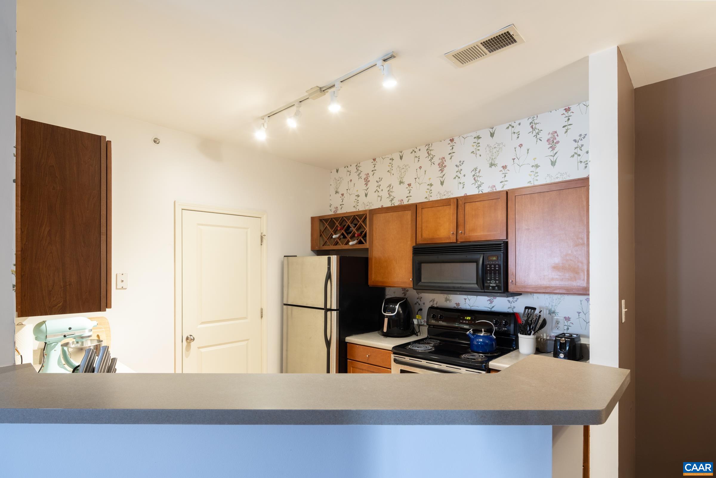 750 Walker Square, Unit 3D Charlottesville, VA 22903 - Photo 8 of 18 a kitchen with a refrigerator a sink and a microwave