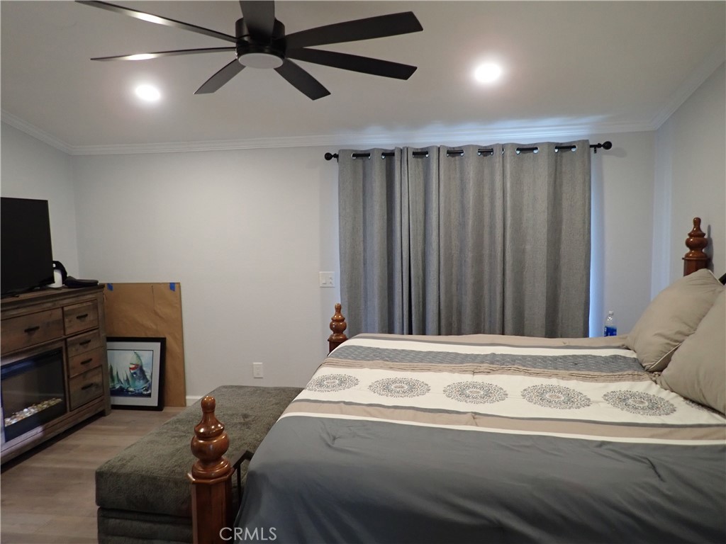 27250 Murrieta Road, Unit 386 Menifee, CA 92586 - Photo 24 of 32 a bedroom with a bed and a television