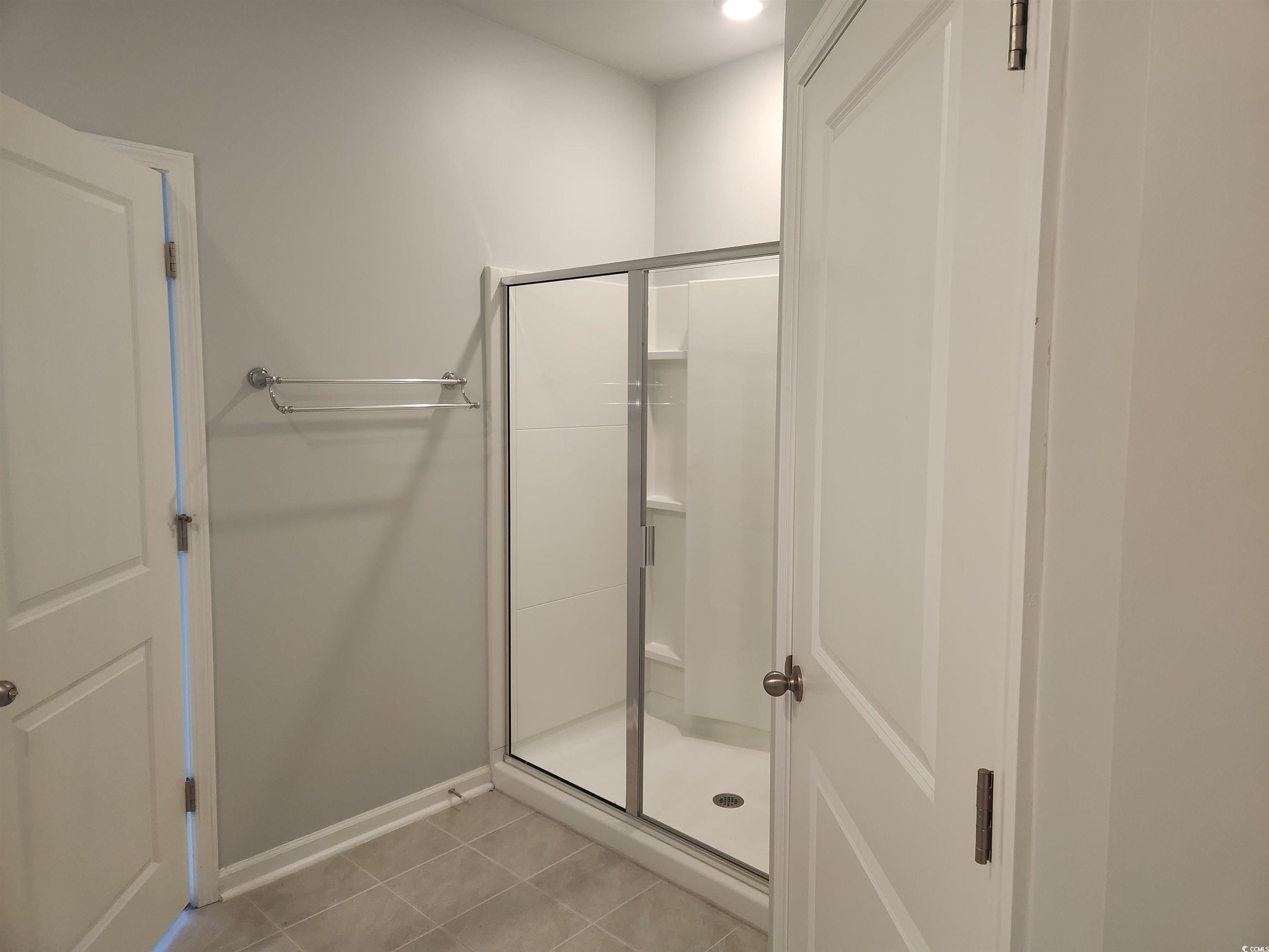 174 Sea Shell Drive Murrells Inlet, SC 29576 - Photo 11 of 16 Full bathroom with a stall shower and tile patterned floors