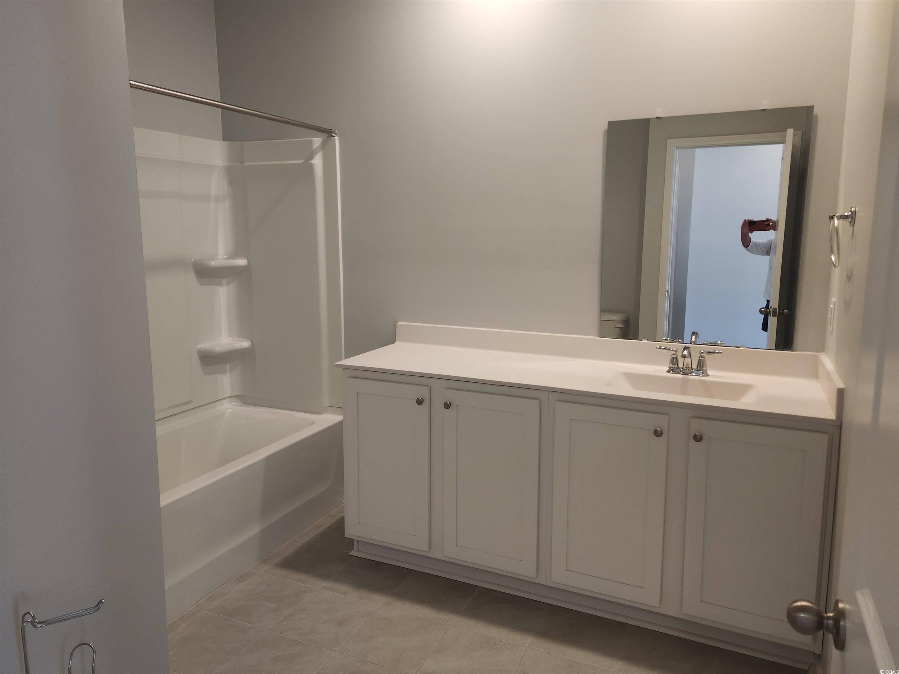 174 Sea Shell Drive Murrells Inlet, SC 29576 - Photo 14 of 16 Full bath with shower / washtub combination, vanity, and tile patterned floors
