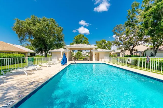 a bathroom with a granite countertop sink a mirror and a bathtub