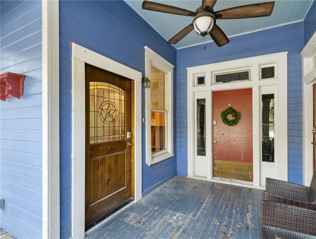 3210 Hampton Road, Unit A B C Austin, TX 78705 - Photo 31 of 42 Front porch featuring blue siding, white trim, two entry doors, and a wood-finish ceiling fan