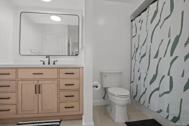 a bed room with a bed and a ceiling fan