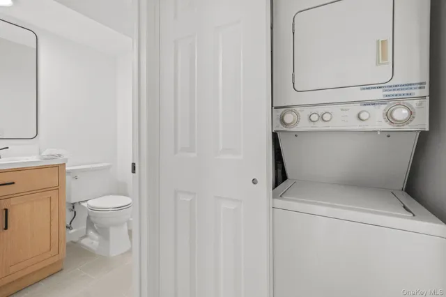 a bathroom with a toilet sink vanity and mirror