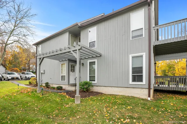 a view of a hallway with wooden door and windows