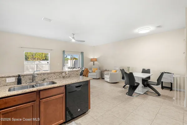 a kitchen with a sink and chairs