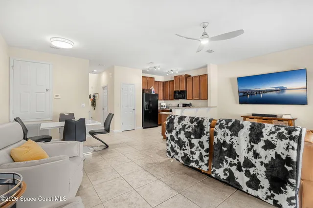 a large kitchen with stainless steel appliances kitchen island granite countertop a refrigerator and a stove top oven