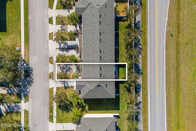 an aerial view of a house with a garden