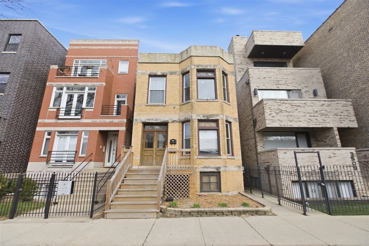 a front view of a residential apartment building with a garage