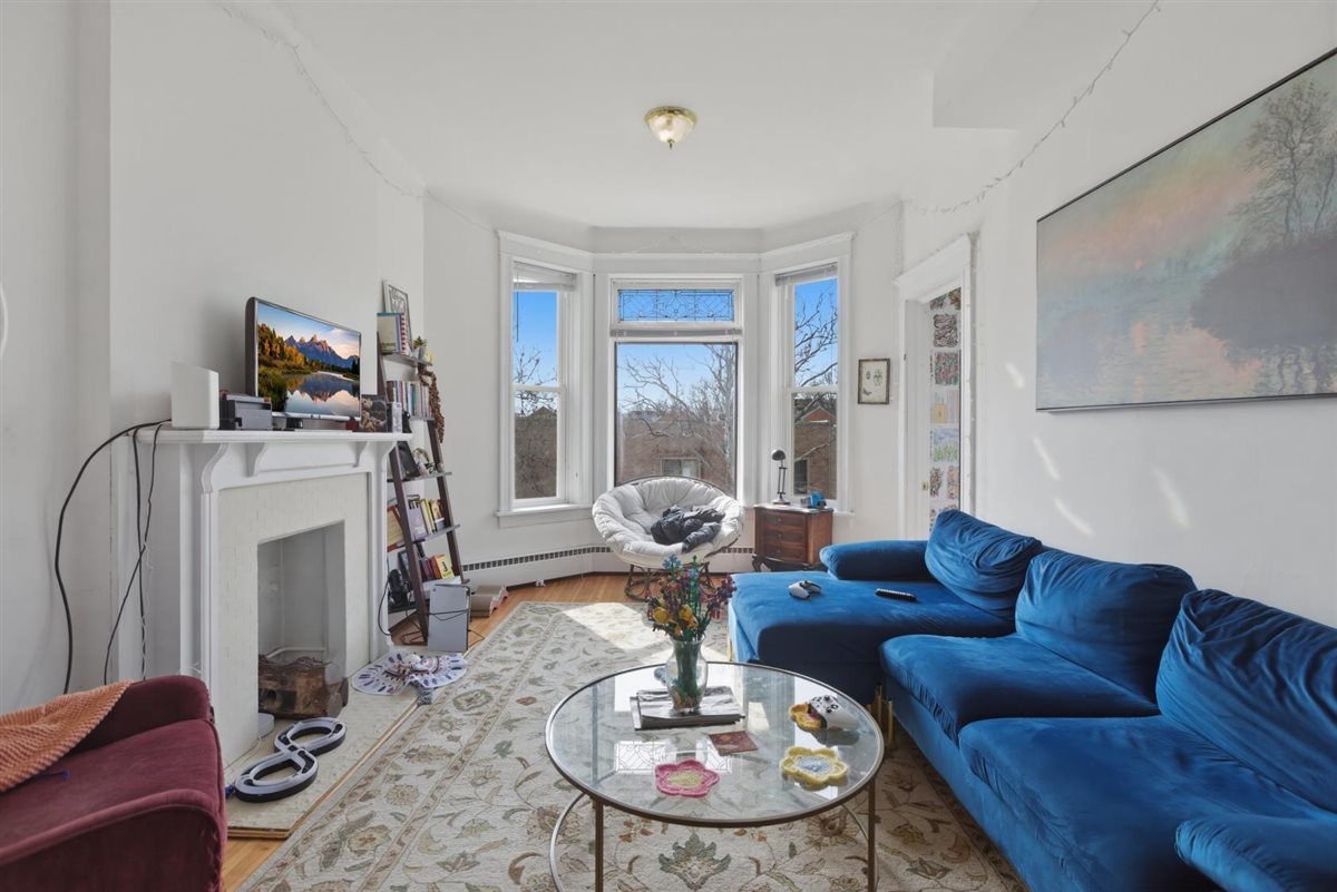 3507 North Seminary Avenue, Unit 2F Chicago, IL 60657 - Photo 3 of 10 a living room with furniture a fireplace and a table