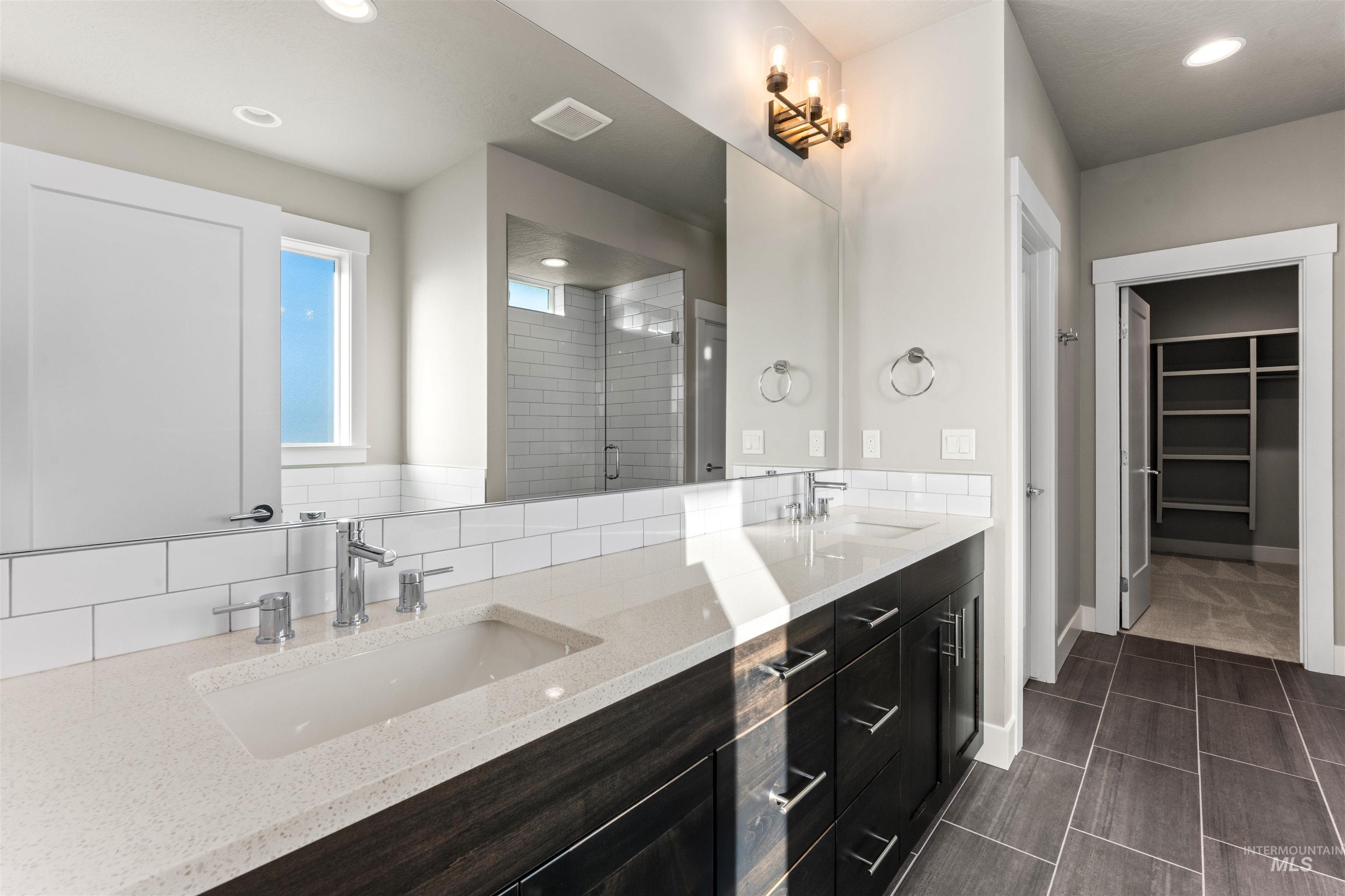 8097 Tandy Cove Street Middleton, ID 83644 - Photo 21 of 37 Bathroom with a spacious closet, a shower stall, double vanity, and recessed lighting