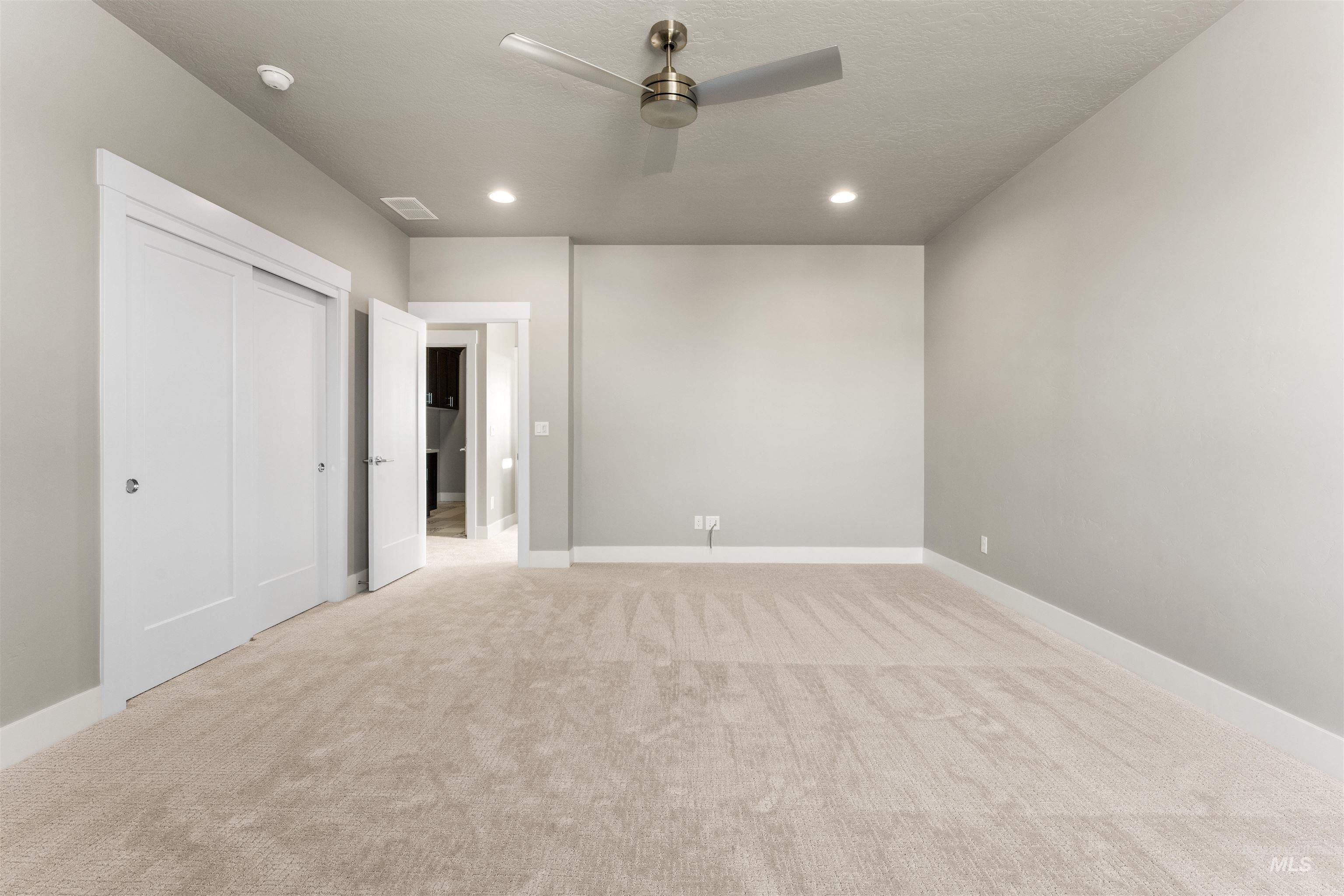 8097 Tandy Cove Street Middleton, ID 83644 - Photo 26 of 37 Unfurnished bedroom featuring light carpet, a ceiling fan, recessed lighting, and a closet