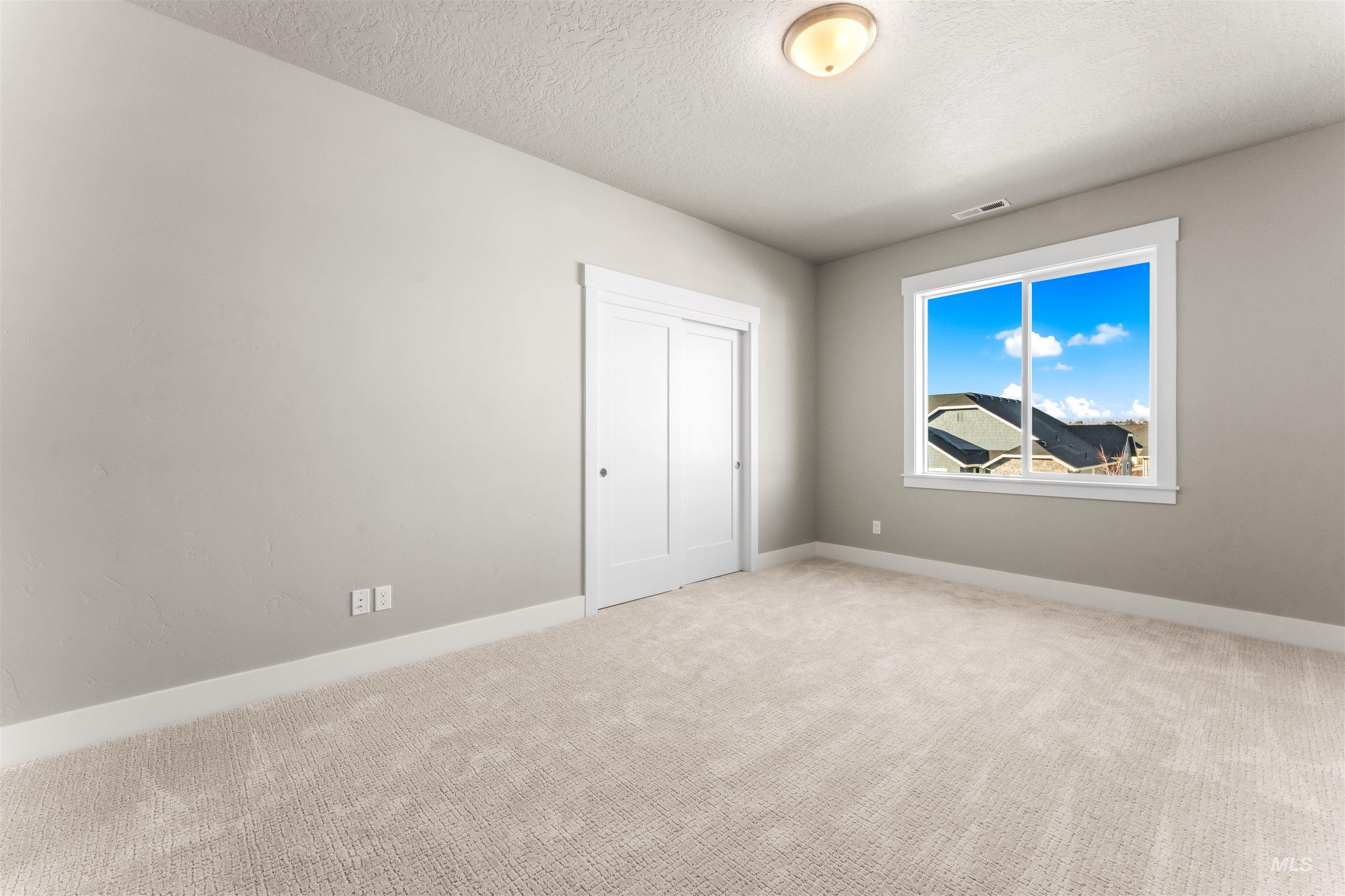 8097 Tandy Cove Street Middleton, ID 83644 - Photo 29 of 37 Unfurnished bedroom with light carpet and a textured ceiling