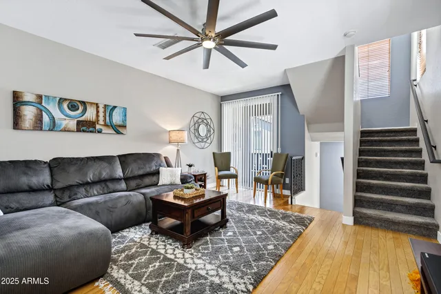 a living room with furniture and wooden floor