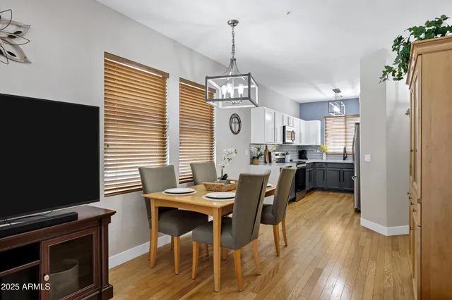 a dining room with furniture and wooden floor
