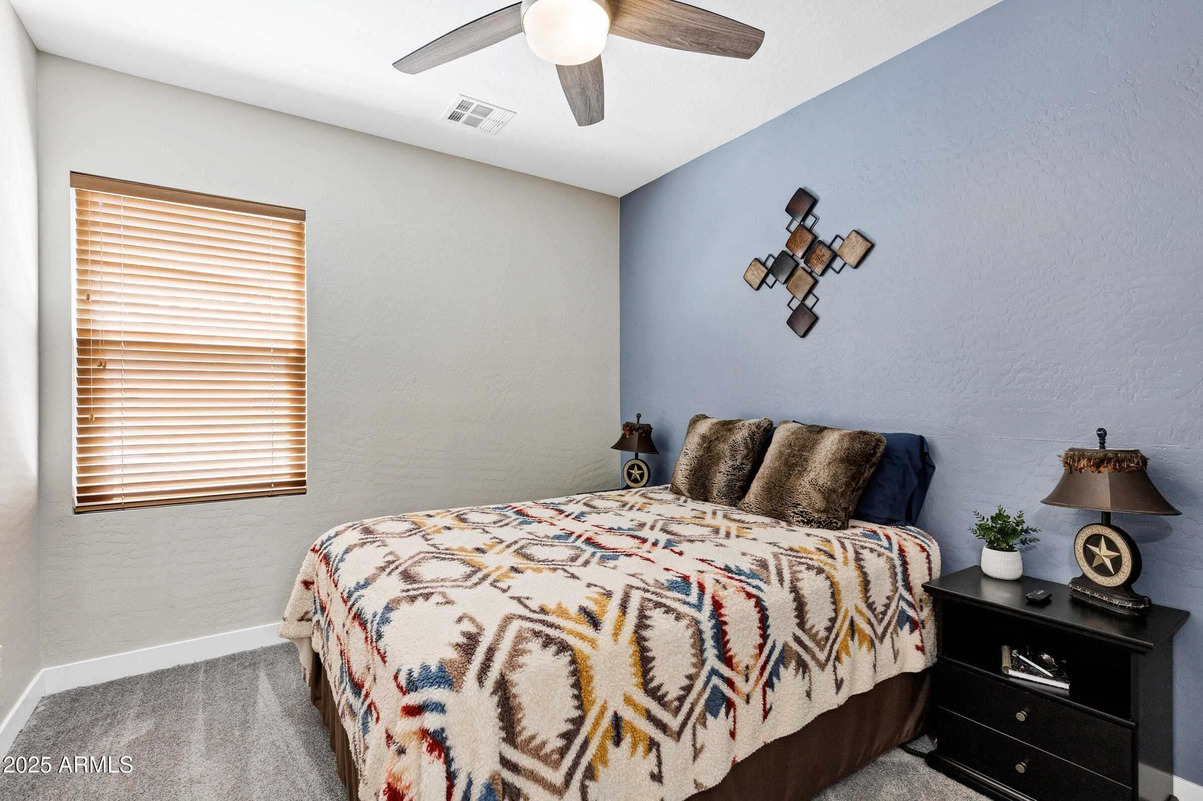 945 West Wendy Way Gilbert, AZ 85233 - Photo 19 of 35 a bedroom with a bed and a chandelier