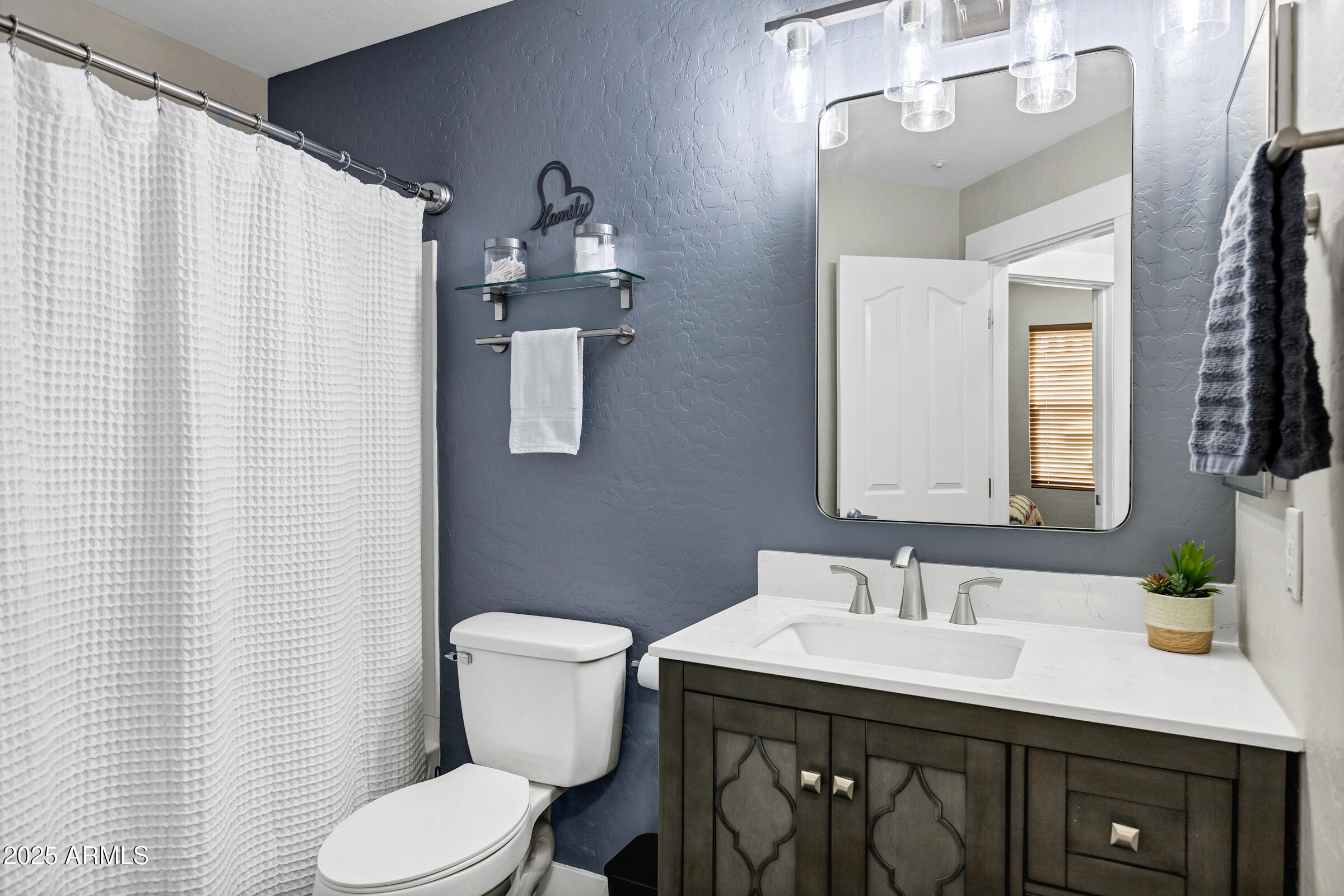 945 West Wendy Way Gilbert, AZ 85233 - Photo 20 of 35 a bathroom with a granite countertop sink and a mirror