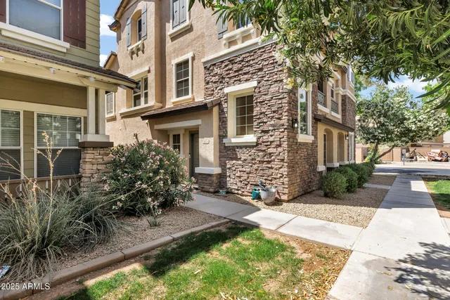 a view of a yard with plants and trees