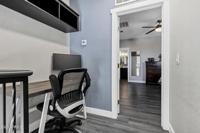 a view of a hallway with couch and wooden floor