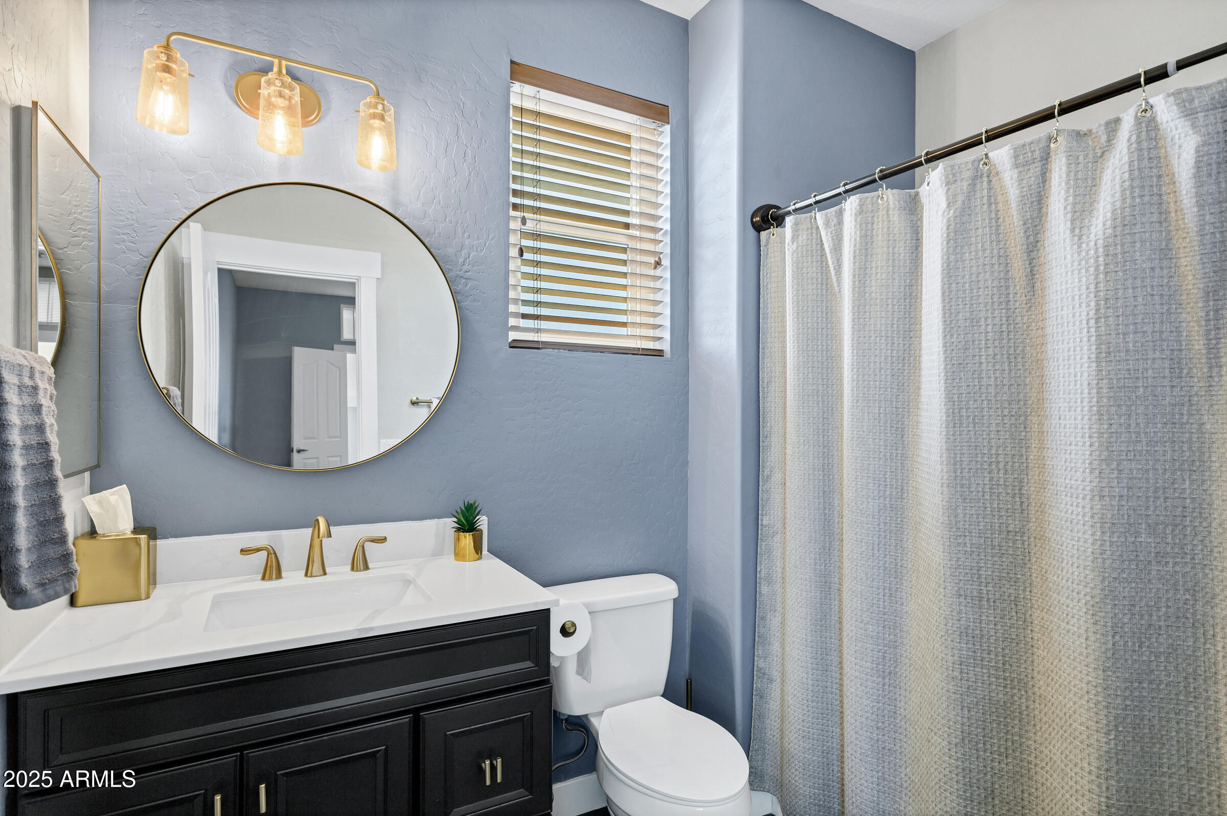 945 West Wendy Way Gilbert, AZ 85233 - Photo 28 of 35 a bathroom with a sink a toilet and a mirror