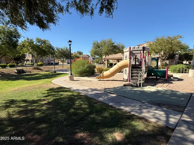 a view of a park with swings and slides