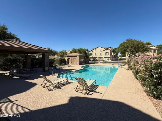 a view of a house with pool and a yard