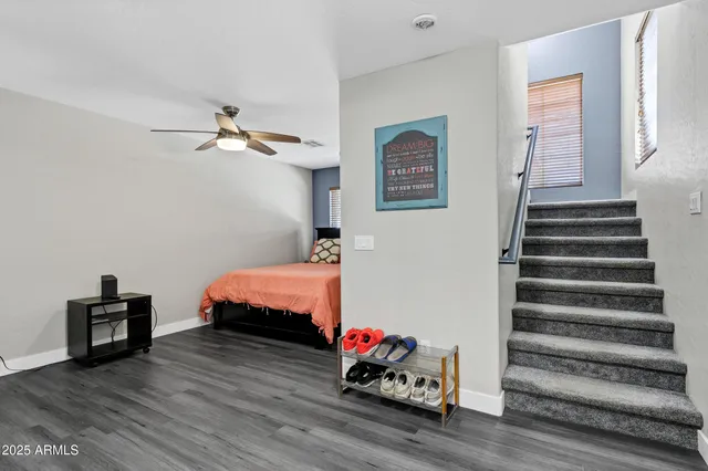 a bedroom with bed and a chandelier