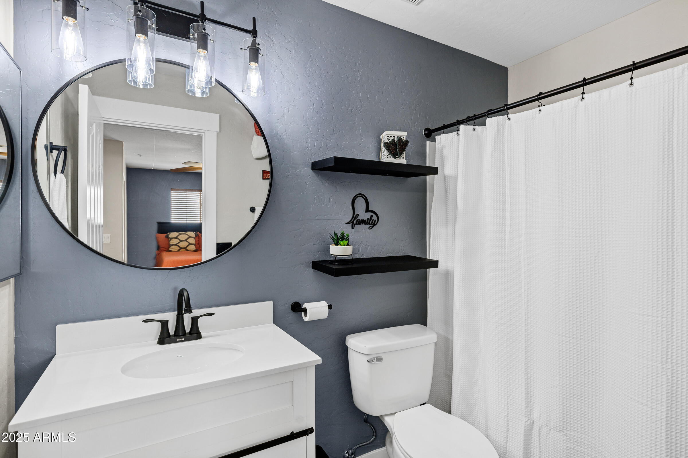 945 West Wendy Way Gilbert, AZ 85233 - Photo 9 of 35 a bathroom with a toilet sink and mirror