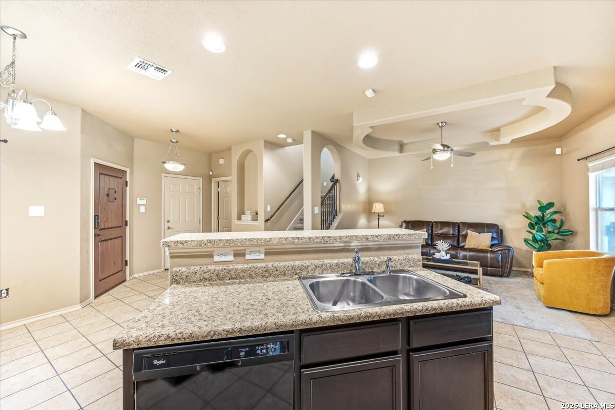 3831 Bacall Way Converse, TX 78109 - Photo 12 of 33 a view of a kitchen with kitchen island a sink stainless steel appliances and cabinets