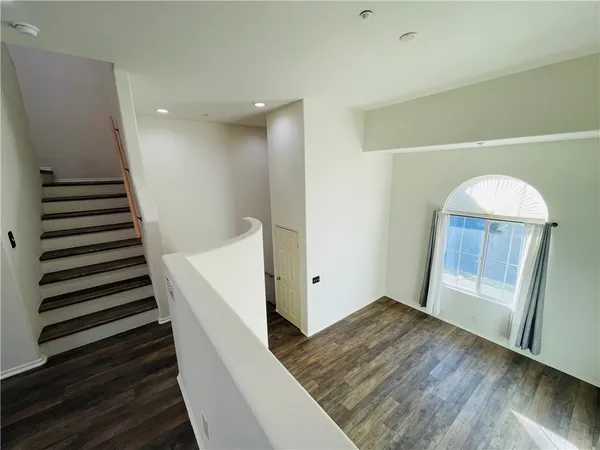 wooden floor in an empty room with wooden floor and stairs