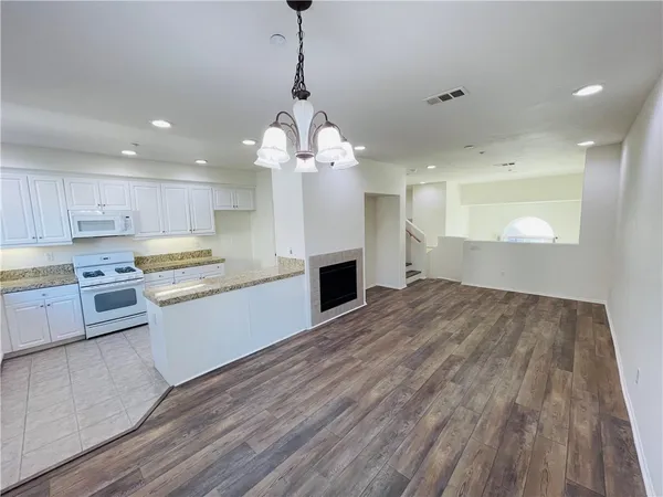 a large kitchen with kitchen island a sink stainless steel appliances and cabinets