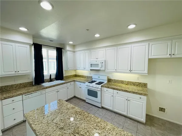 a kitchen with a sink window and cabinets