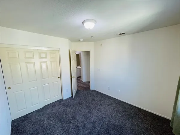 an empty room with closet area