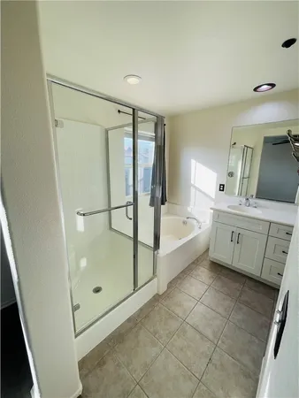 a bathroom with a sink a mirror and a bath tub