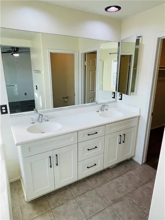 a bathroom with a double vanity sink and a mirror