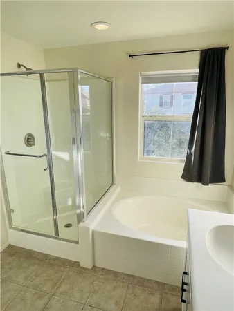 a bathroom with a bathtub a sink and a shower