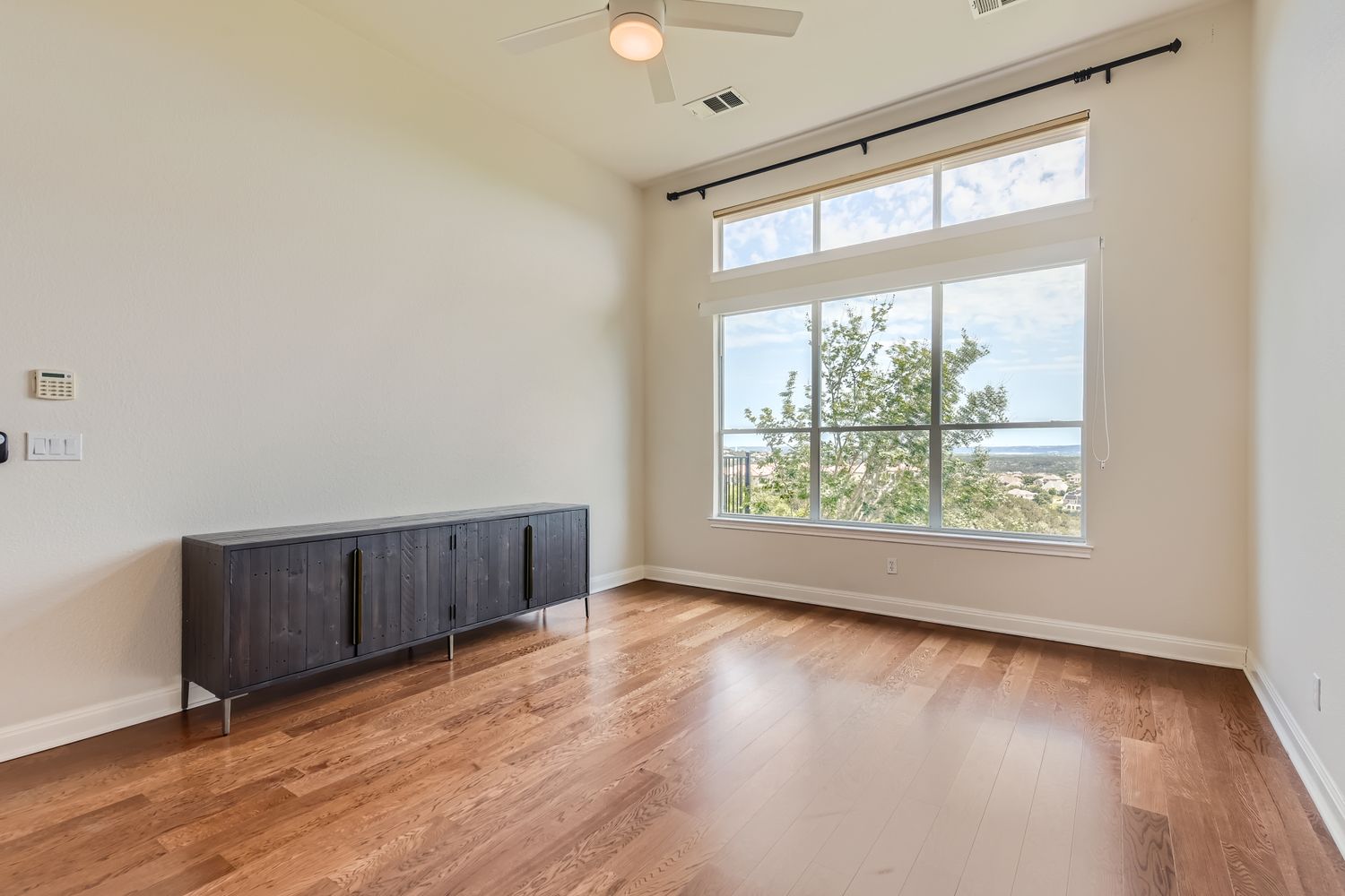 236 Aria Ridge, Unit 236 Lakeway, TX 78738 - Photo 11 of 24 an empty room with wooden floor and windows