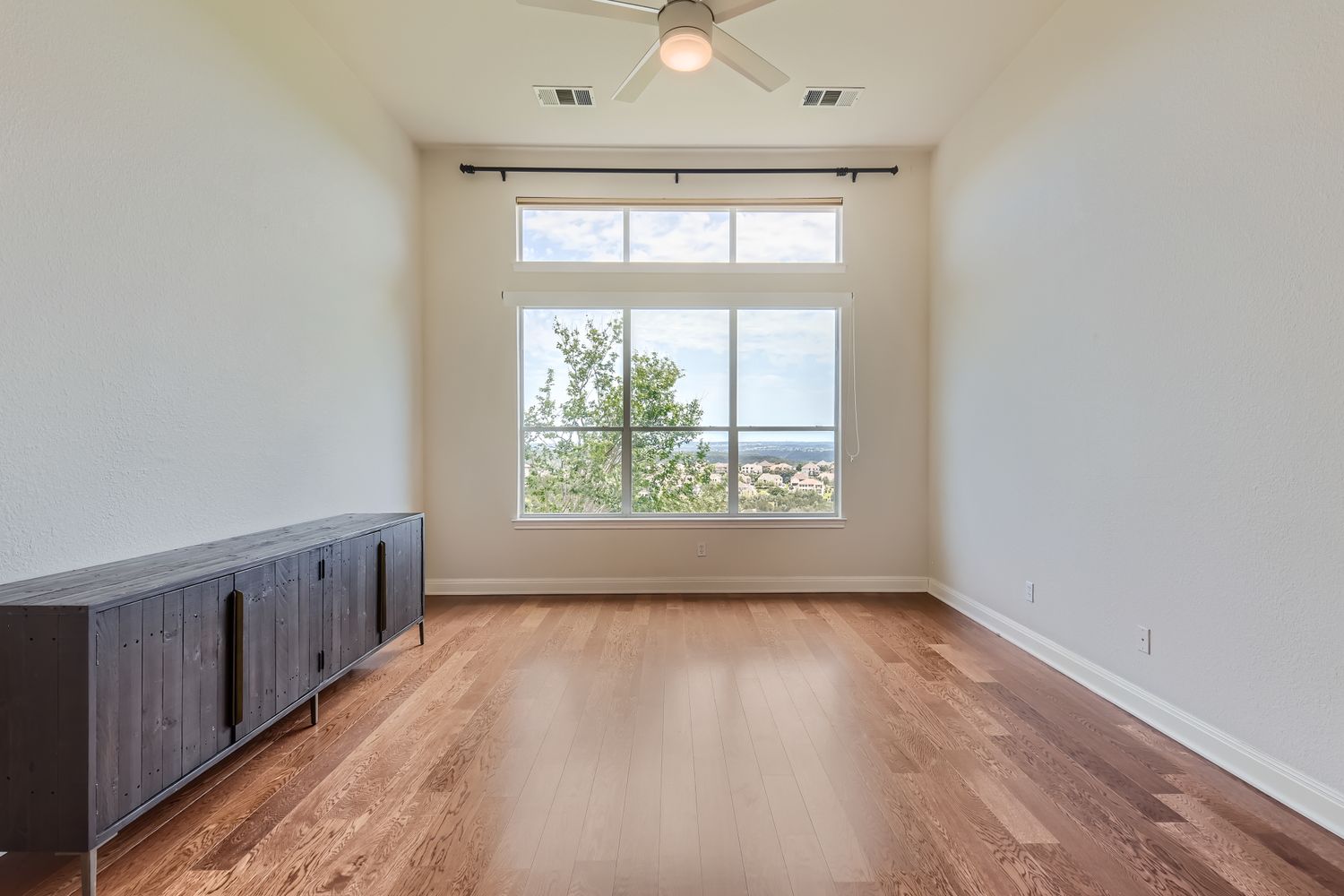 236 Aria Ridge, Unit 236 Lakeway, TX 78738 - Photo 13 of 24 an empty room with wooden floor and windows