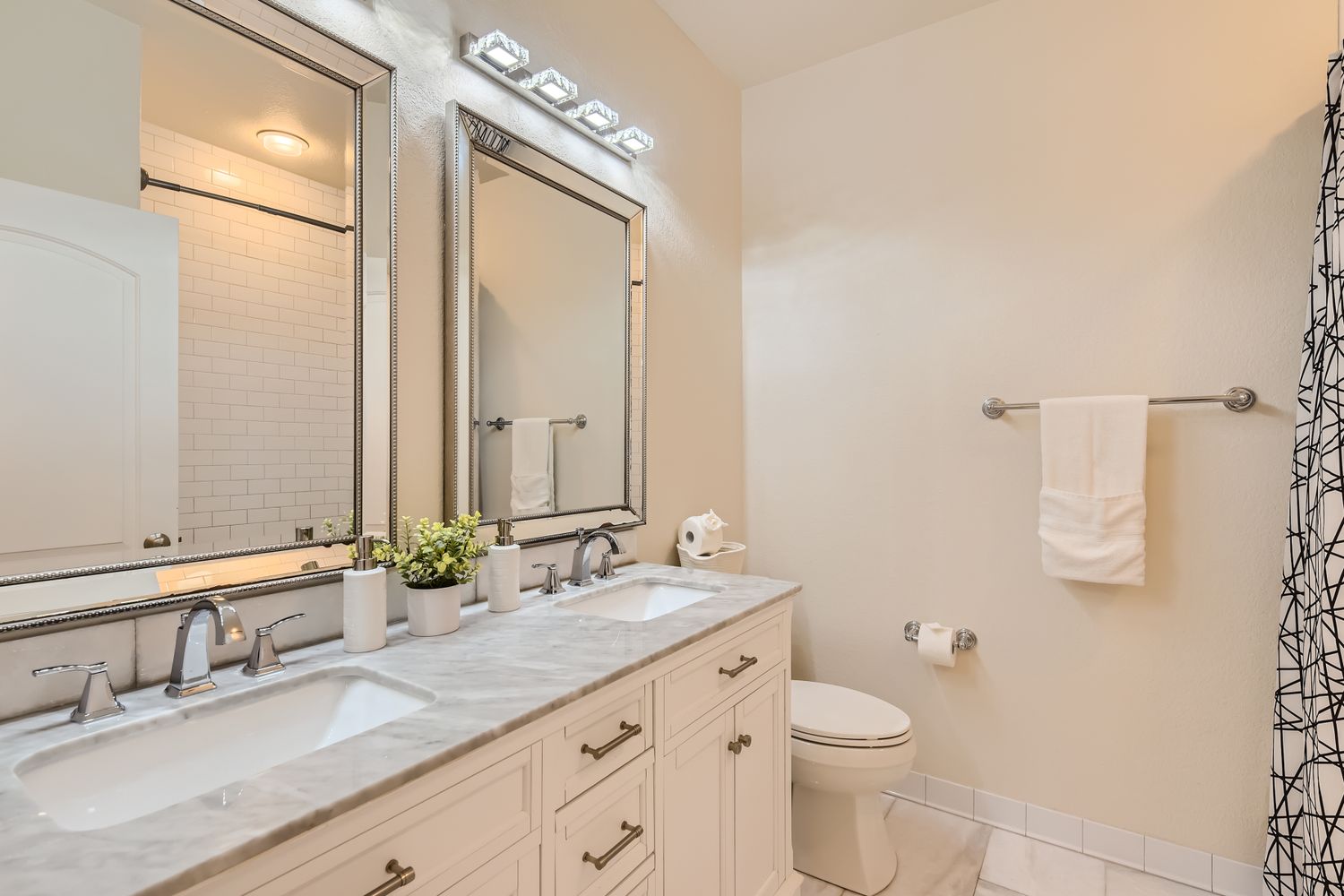236 Aria Ridge, Unit 236 Lakeway, TX 78738 - Photo 16 of 24 a bathroom with a double vanity sink and a mirror