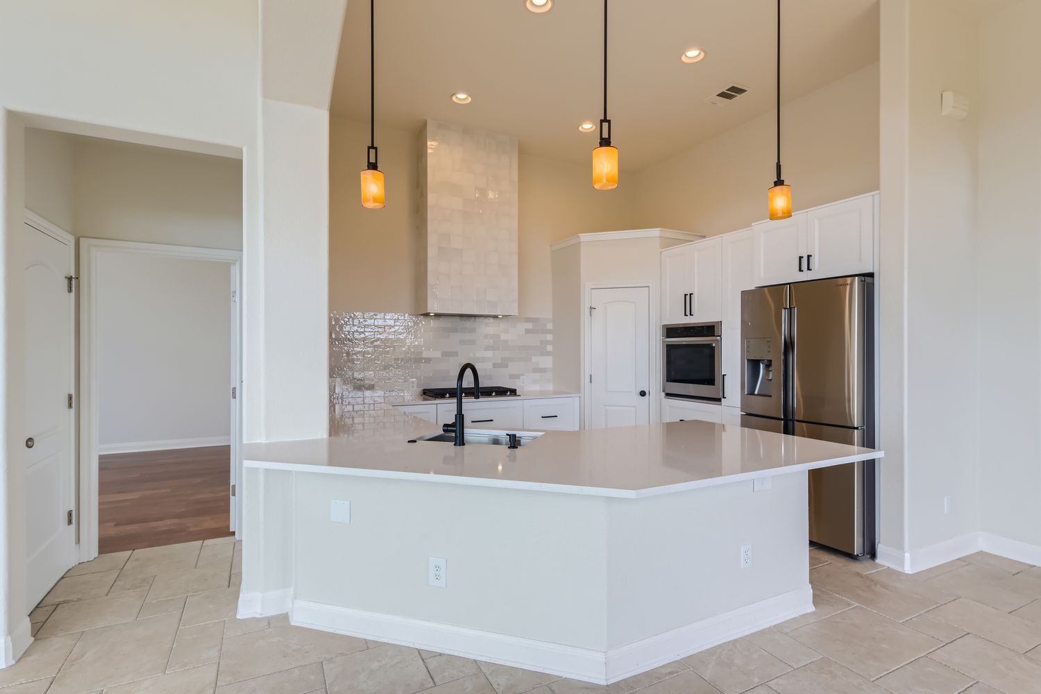 236 Aria Ridge, Unit 236 Lakeway, TX 78738 - Photo 4 of 24 a large kitchen with kitchen island a sink stainless steel appliances and cabinets