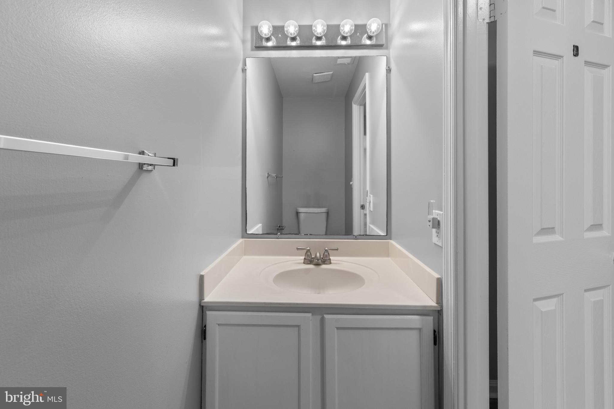 9302 Player Drive, Unit 155 Laurel, MD 20708 - Photo 18 of 43 a bathroom with a sink and a mirror